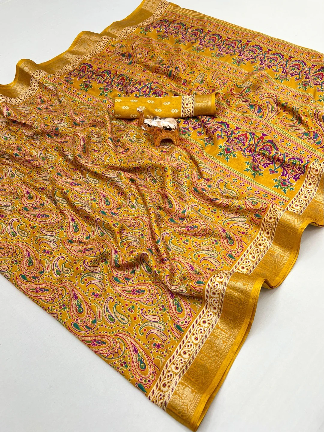 Mustard Paisley Printed Dola Silk Saree with Detailed Zari Border and Graceful Fluid Drape