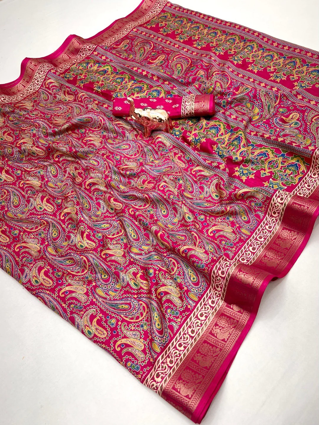 Pink Paisley Printed Dola Silk Saree with Detailed Zari Border and Graceful Fluid Drape