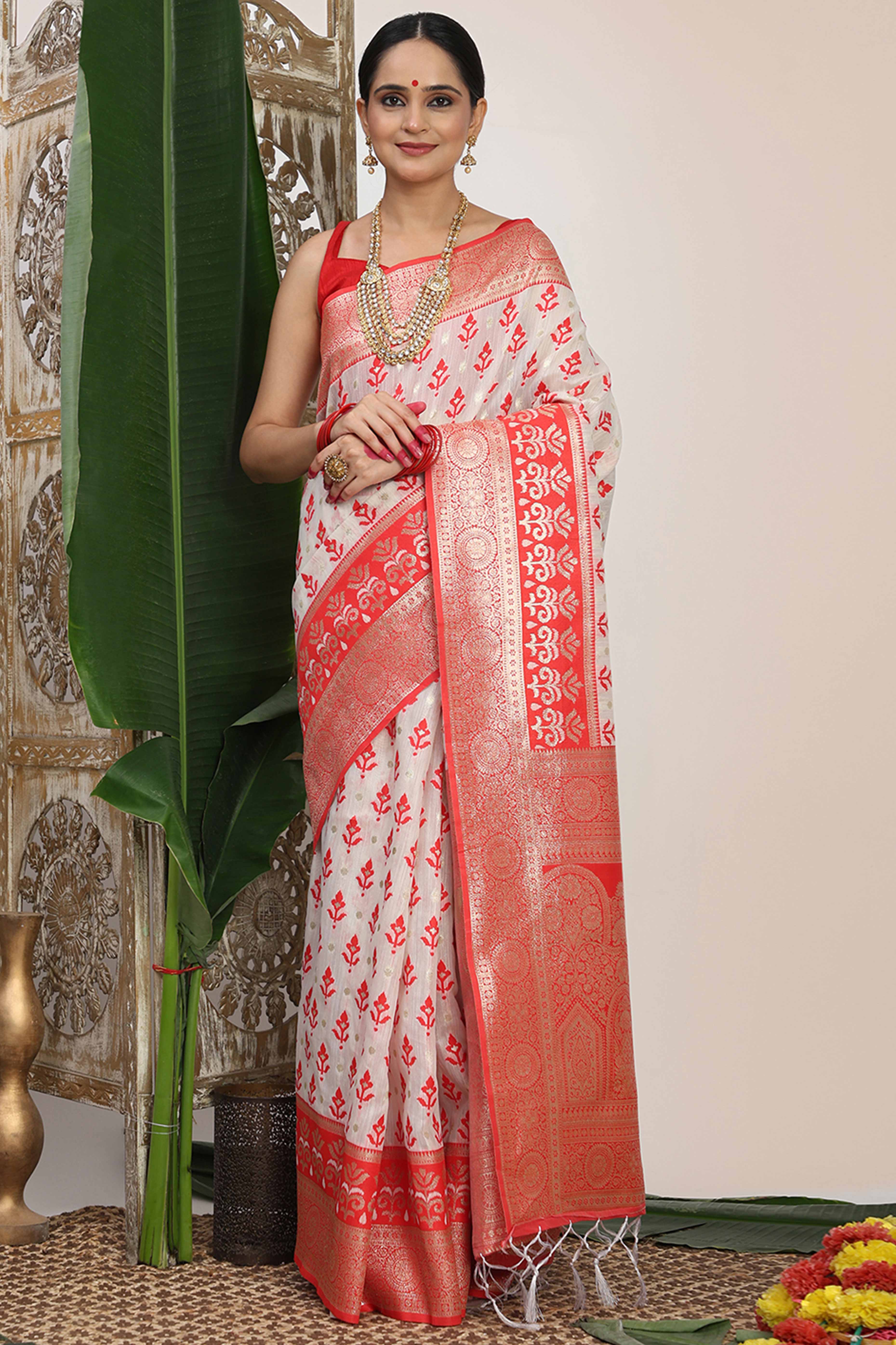 White & Red Linen Cotton Saree Showcasing Elegant Zari Weaving And A Tassel-Embellished Pallu