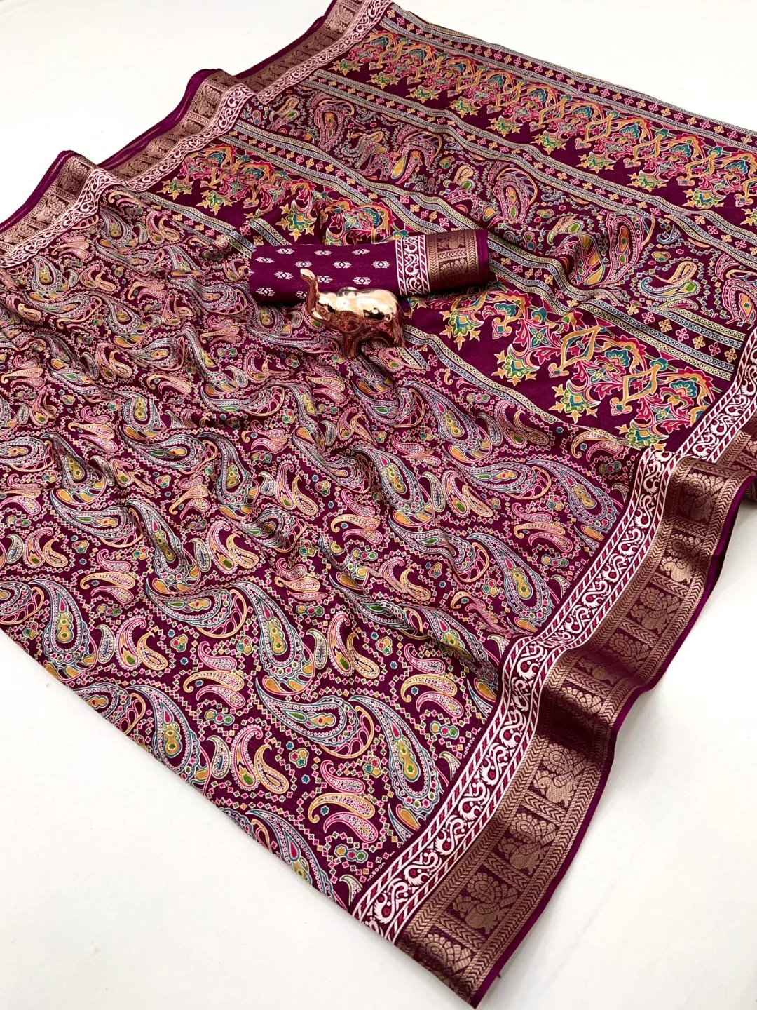 Wine Paisley Printed Dola Silk Saree with Detailed Zari Border and Graceful Fluid Drape